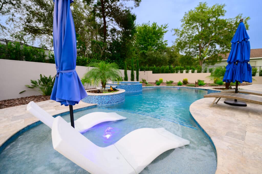 Backyard pool with partially submerged lounge chairs