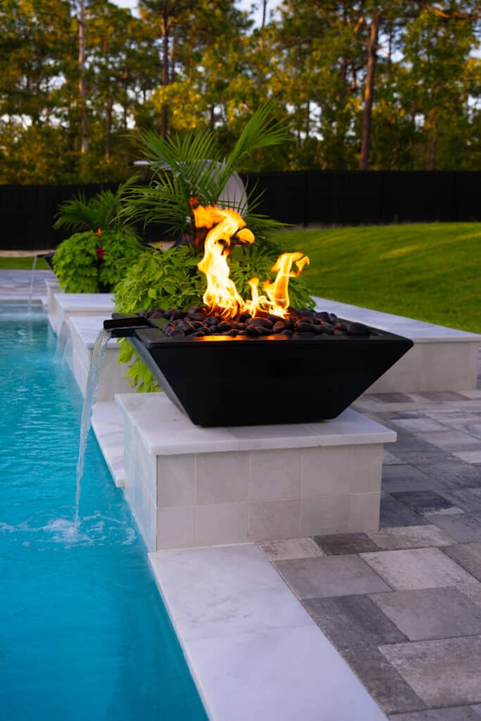 Black fire water bowl feature, adding a touch of elegance to the pool area.