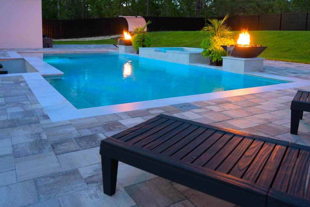 Black fire water bowl feature with vibrant flames, adding a touch of elegance to the pool area in Weeki Wachee, FL