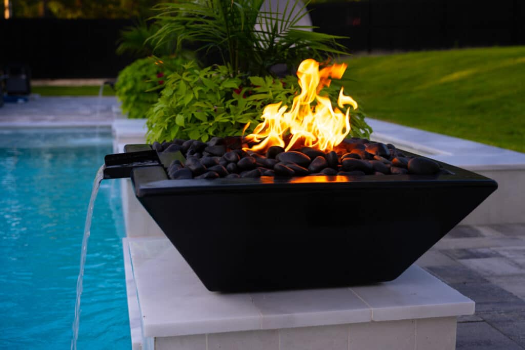 Close-up of a black fire water bowl with bright flames