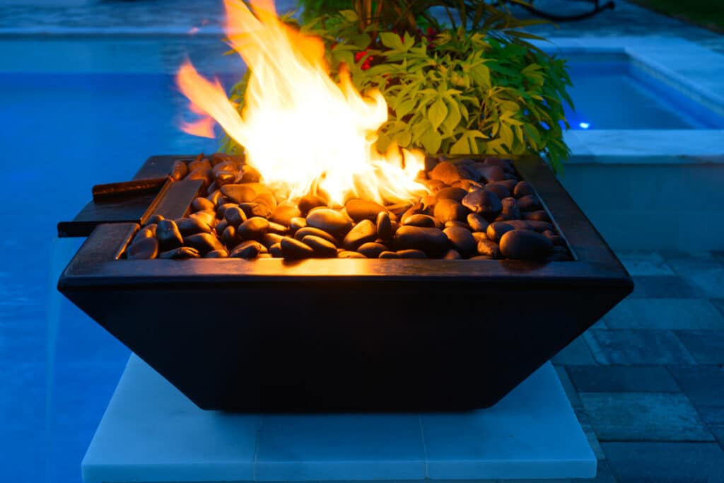 Close-up of a black fire water bowl with vibrant flames