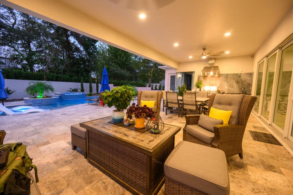 Cozy outdoor seating area in a Weeki Wachee backyard, overlooking a pool with integrated LED lights