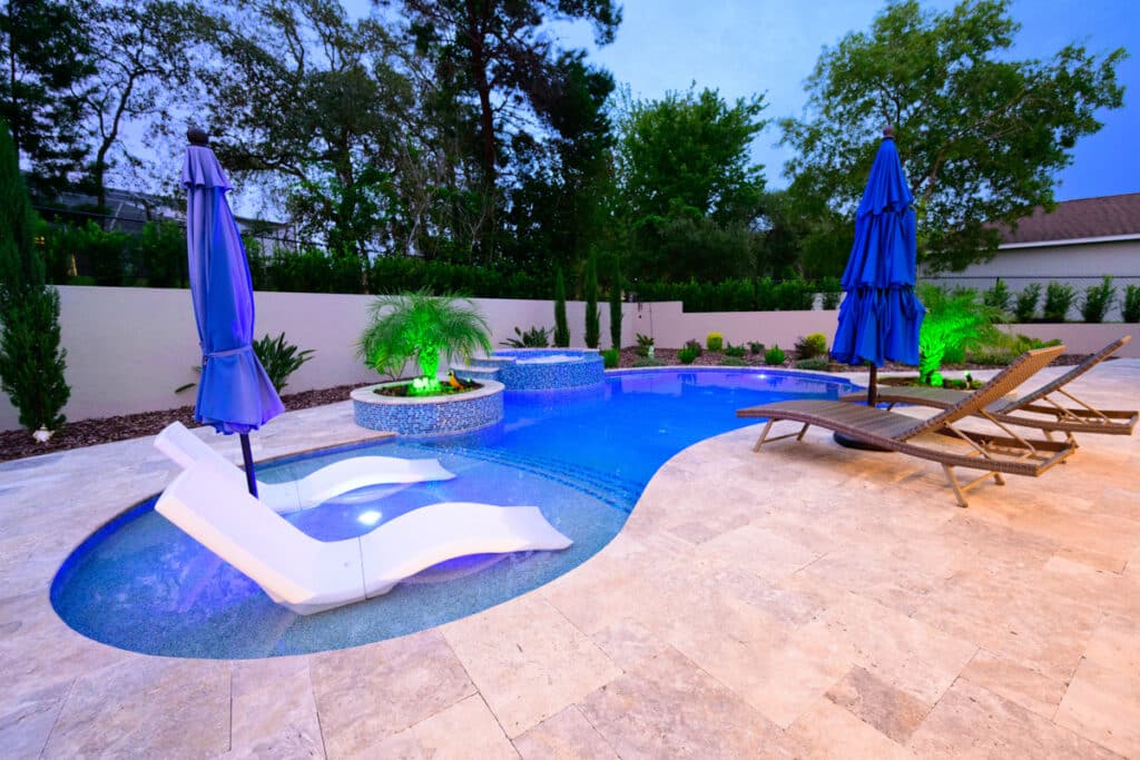 Luxurious backyard pool in Weeki Wachee with lounge chairs on sun shelf