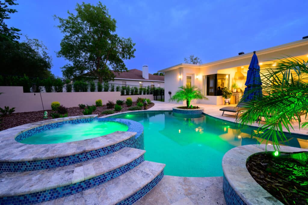 Stylish Weeki Wachee backyard pool with a hot tub