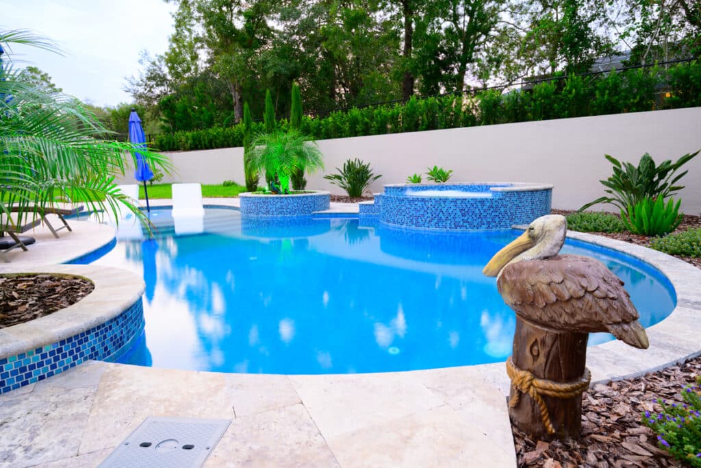 Weeki Wachee backyard pool with a decorative pelican statue