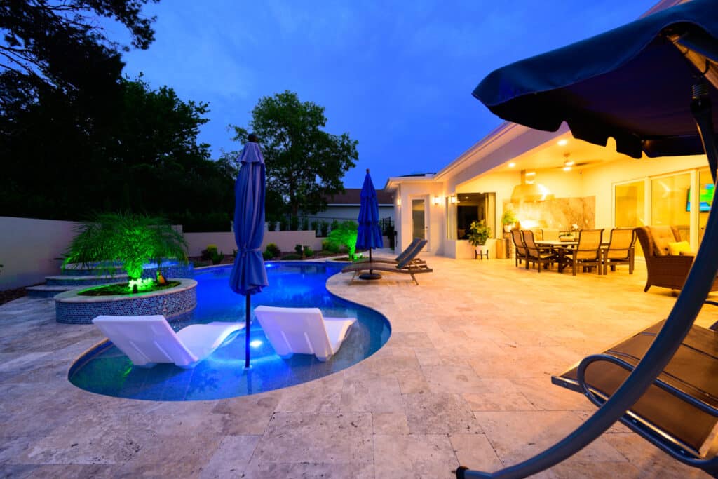 Weeki Wachee backyard pool with lounge chairs in a shallow section