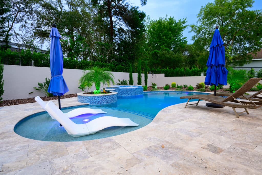 Weeki Wachee backyard pool with lounge chairs on sun shelf