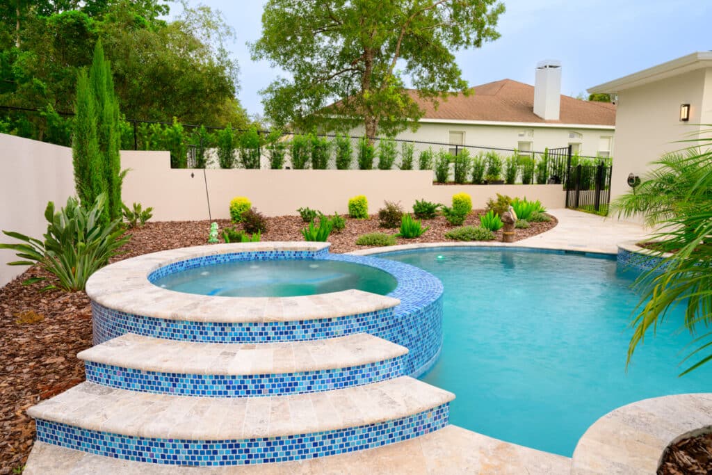 Wide view of a luxurious backyard pool with multiple levels and steps in Weeki Wachee Fl