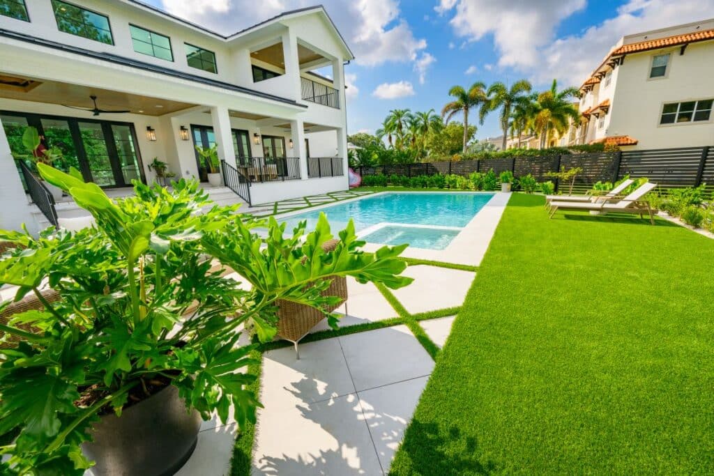 Cozy outdoor seating area with views of the green lawn and pool.