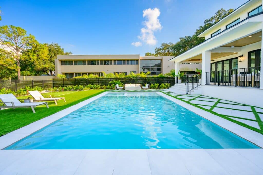 Elegant backyard pool with clean lines and light stone pavers.