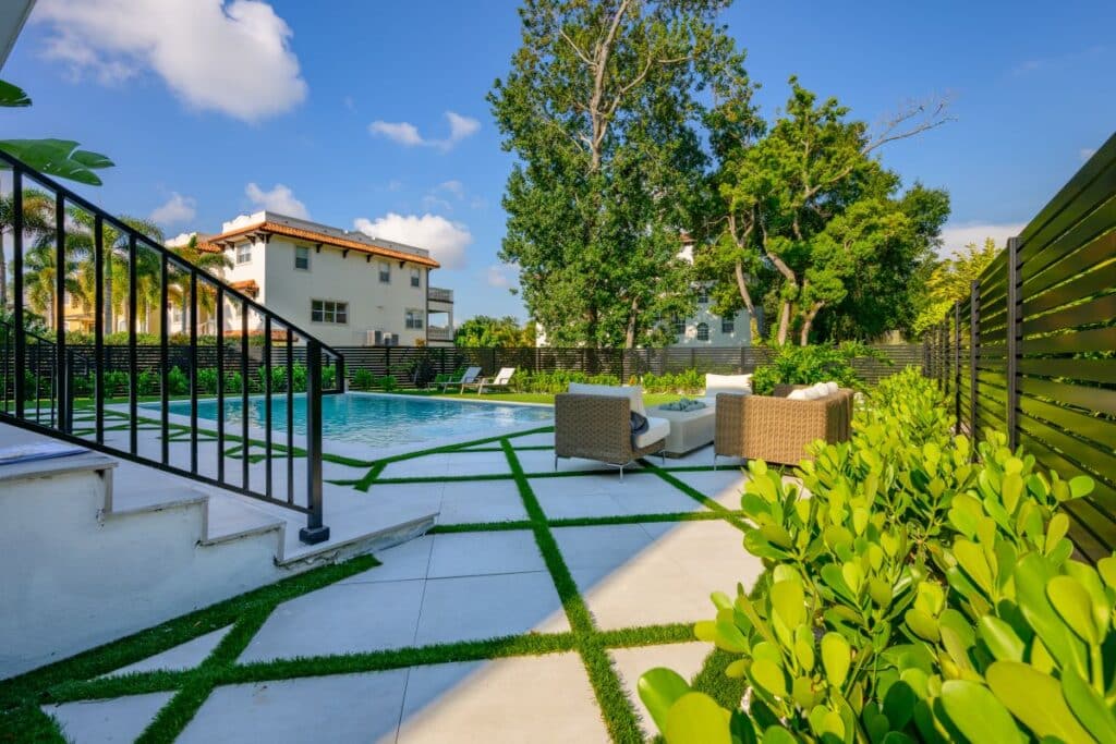 Modern backyard pool with geometric stone pavers.