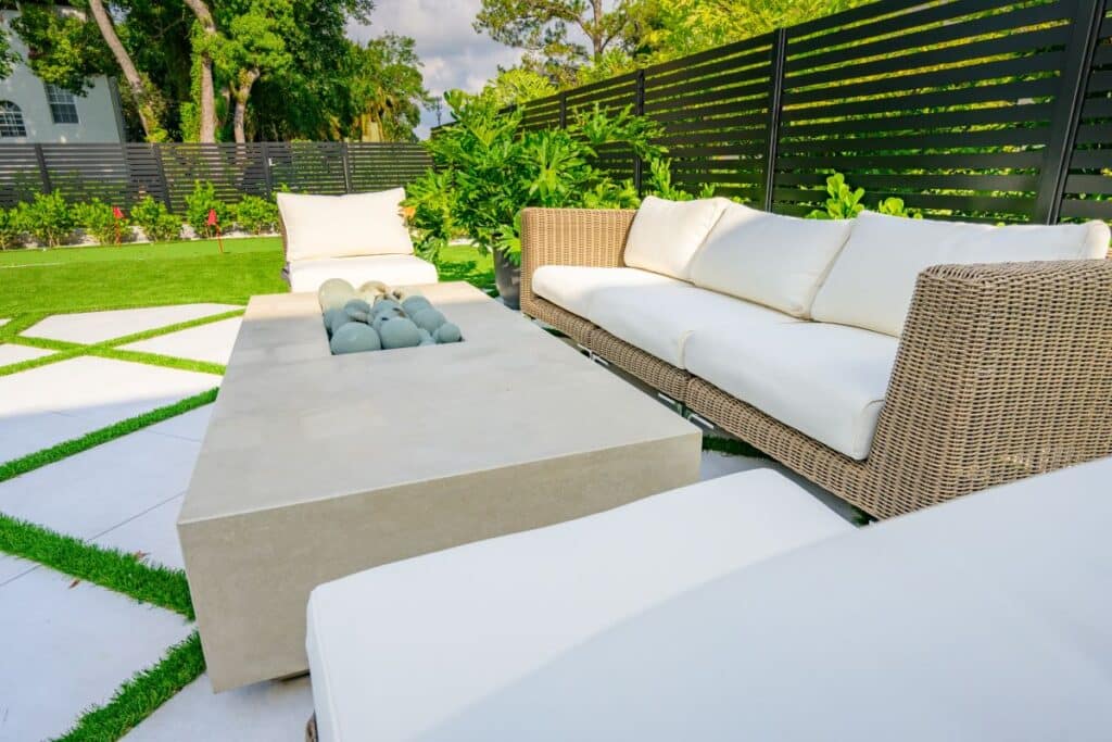 Outdoor seating area with cozy wicker furniture near the pool.