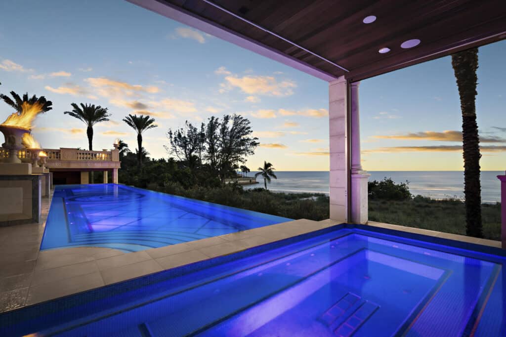 Contemporary Tampa pool with blue LED lighting and a seamless edge, perfect for evening relaxation and gatherings.