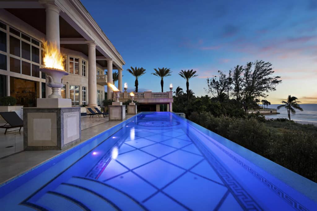 Elegant Tampa pool with clean lines and ambient lighting, designed for a seamless indoor-outdoor living experience.