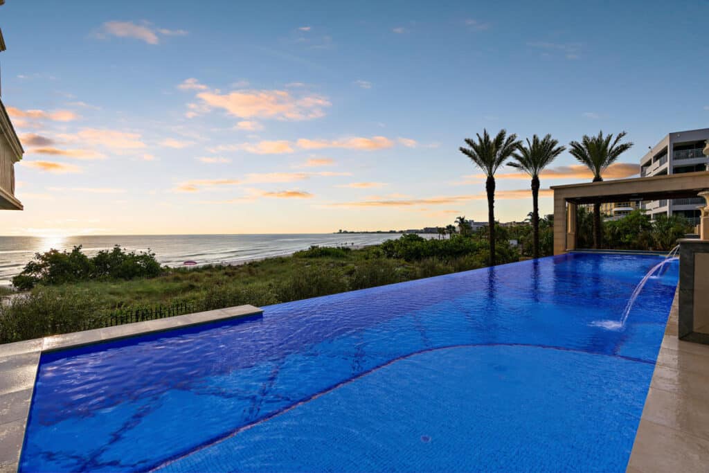 Elegant pool in Tampa with sleek lines and palm trees, offering a tranquil and picturesque backyard retreat.