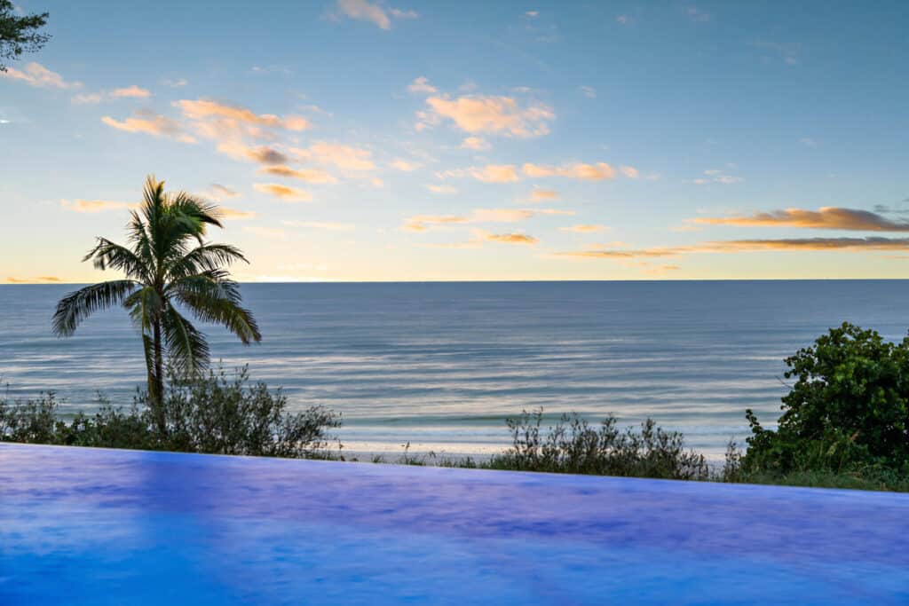 Infinity-edge pool in Tampa overlooking the ocean, offering a tranquil and luxurious backyard retreat.