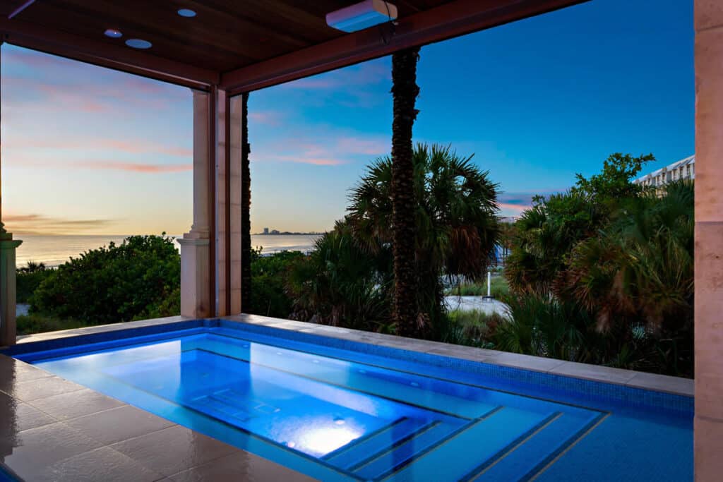 Infinity-edge pool in Tampa with panoramic water views, combining minimalist design with a luxurious feel.