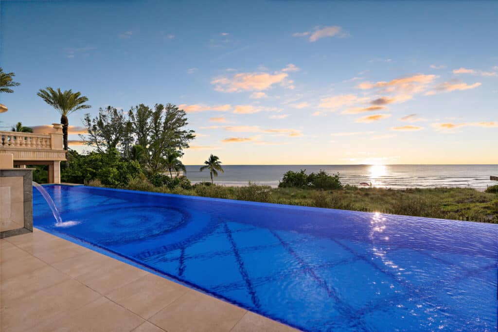 Stylish infinity pool in Tampa with a spacious deck and unobstructed ocean views, blending luxury and tranquility.