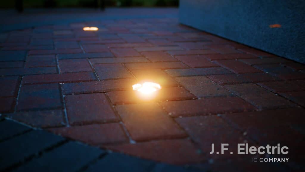 Ground-level view of J.F. Electric's lighting work at the Southern Hills Veterans Memorial, illuminating the paver details.